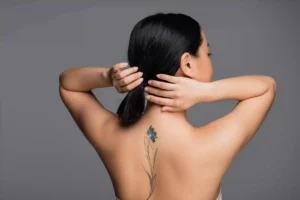 woman with tattoo on back.