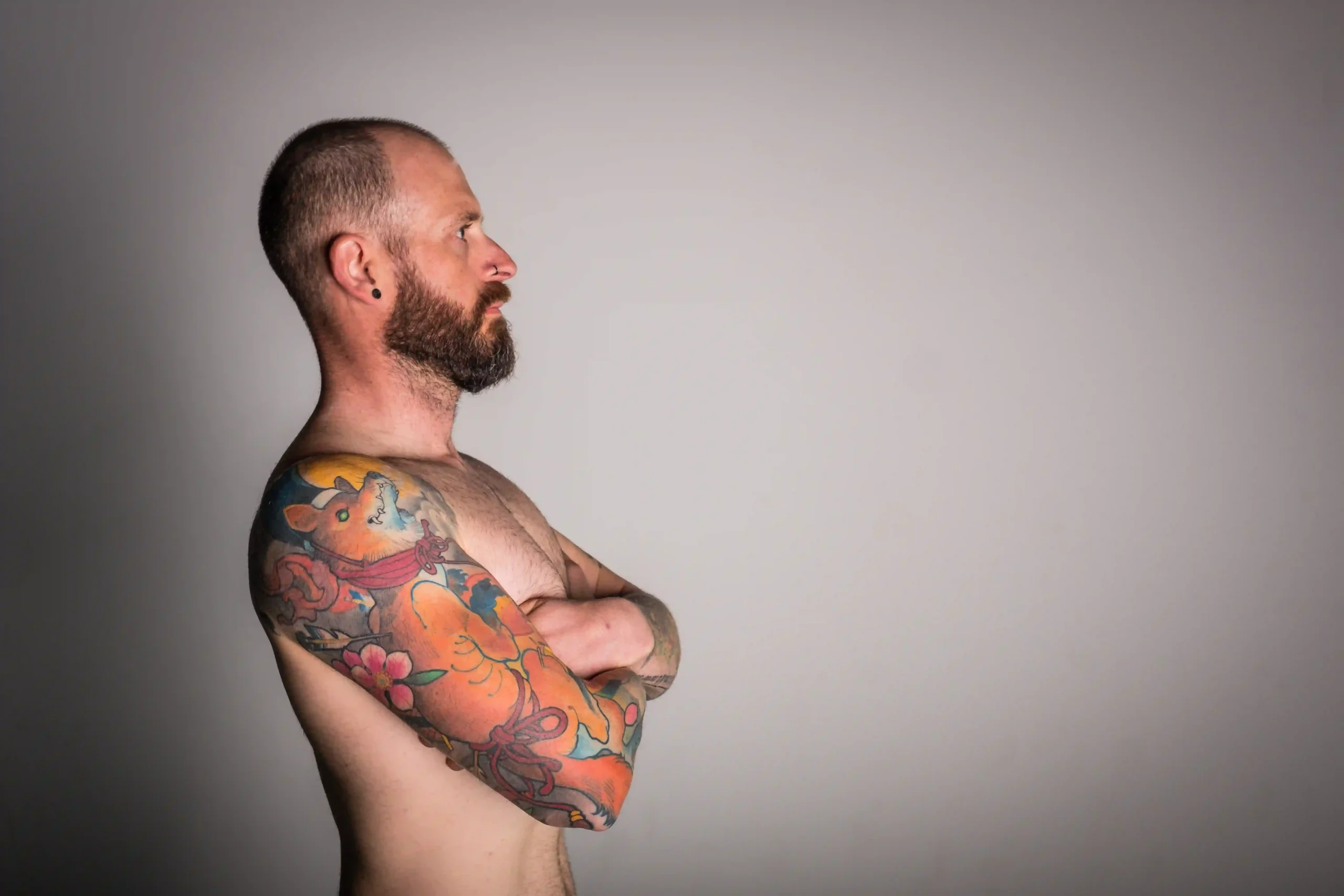 A man with tattoo on hand thinking the truth about tattoo removal.