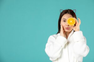 Front view young female holding orange slice