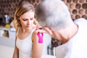 A Doctor applying tape on a pacent.