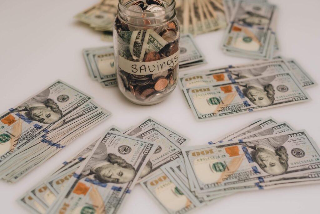 stack of one hundred dollar bills on white table